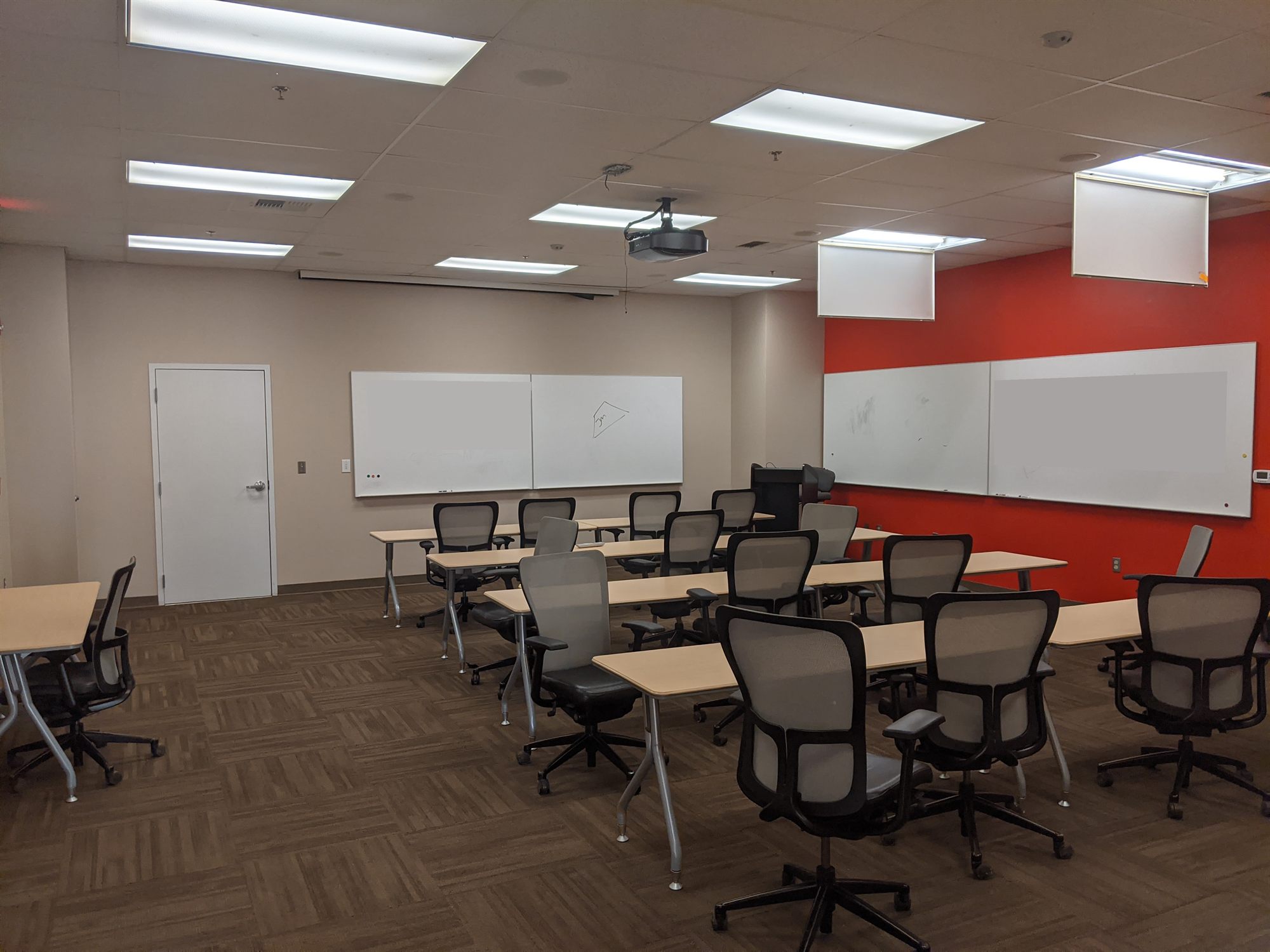 Training room with tables, office chairs, projector and whiteboards